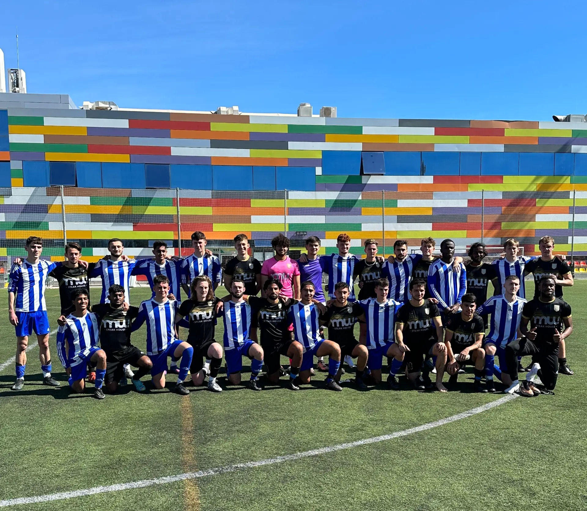 Student football squads posing together on a training pitch