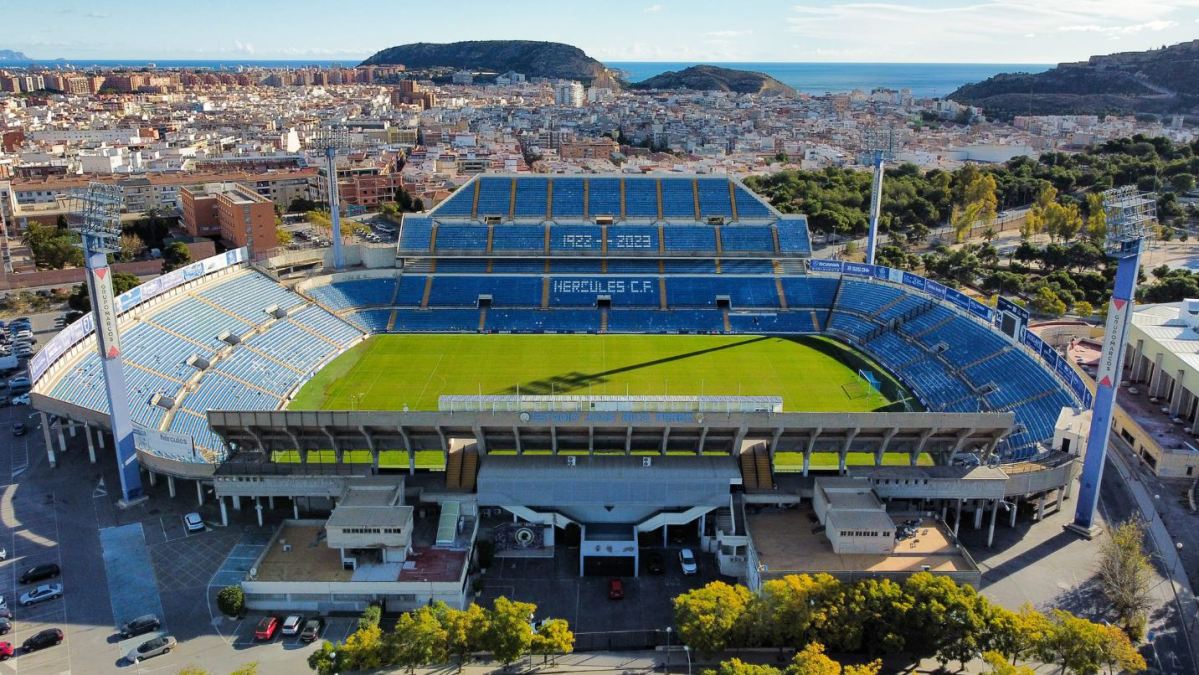 Aerial view of the Estadio José Rico Pérez with the visiting team standing on the pitch